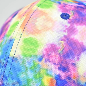 Macro detail of tie-dye baseball cap fabric with reinforced stitching and eyelets