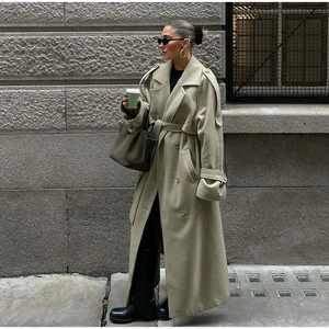 Detail of light olive wool coat featuring wide lapels and a classic double-breasted design