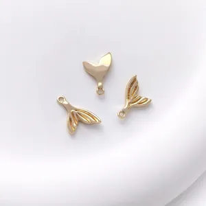 Detailed view of three 14K gold plated whale tail charms for DIY jewelry making and crafts