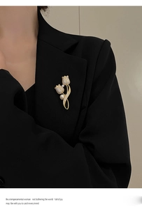 Detail of luxury tulip brooch with pearls and diamonds on black blazer