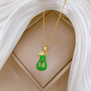 Elegant gold titanium necklace with a green pear-shaped leaf pendant and crystals