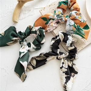 Three-pack of vintage floral satin bow scrunchies in green, yellow, and black colors