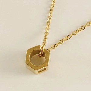 Golden stainless steel necklace with hexagonal nut pendant and small zircon stone