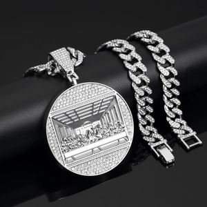 Macro detail of silver iced-out cuban chain and The Last Supper pendant with rhinestones
