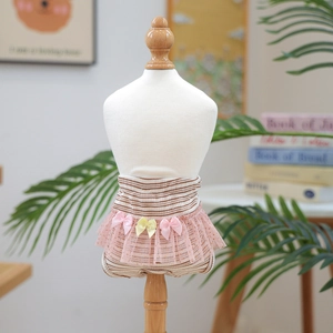 Detail of dog sanitary pants featuring brown stripes, pink tulle skirt and bow knots