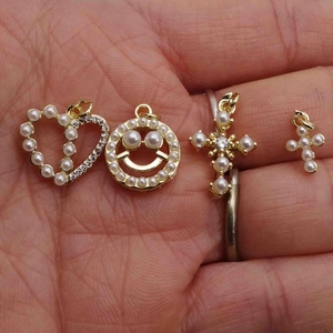 Gold pendants with pearls and zircons including heart, smiley face and cross charms