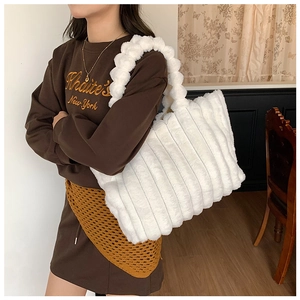 Close-up of plush white faux fur texture and large capacity design of the tote bag