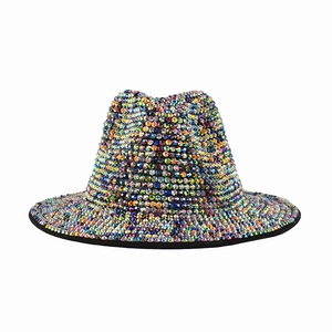 Close-up of rainbow rhinestones on a sparkling fedora hat showing colorful light reflections