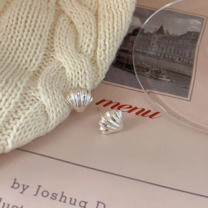 Minimalist 925 sterling silver shell stud earrings with a textured metallic finish