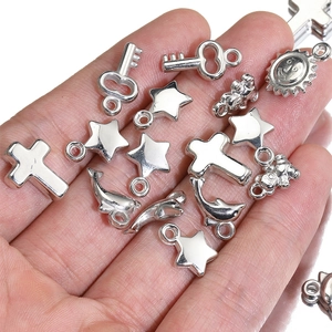 Y2K style silver metal charms including star, cross, and dolphin shapes for DIY jewelry