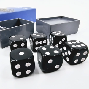 Detail of 6 black magic dice set with grey storage case and blue packaging box