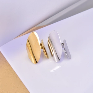 Minimalist wide drop open rings in polished 18K gold and silver finishes on wood surface