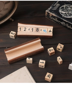 Detail view of the wooden perpetual calendar with natural bark edges and movable date blocks