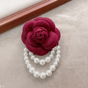 Elegant burgundy fabric camellia brooch with white pearl tassels and floral charm