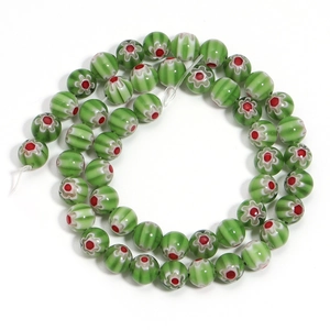 Macro shot of green millefiori glass beads arranged in a circle for DIY jewelry making