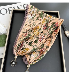 Detailed view of floral pleated silk scarf necklace with pearl flower pendant in gift box