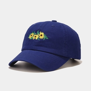 Detail of navy blue cotton baseball cap featuring three yellow sunflower embroideries
