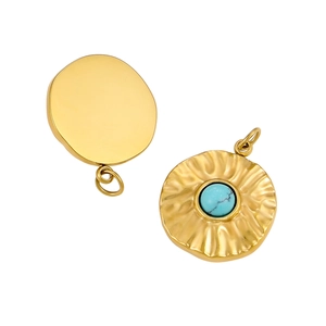 Macro detail of gold stainless steel pendants with turquoise stone and hammered texture