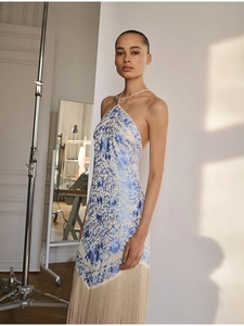 Detail view of floral halter dress featuring elegant tassels and an open back design