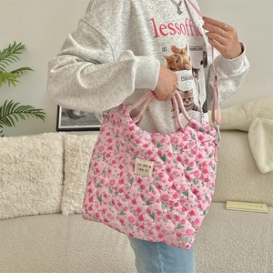 Detailed shot of pink quilted cotton tote bag with floral pattern and adjustable strap