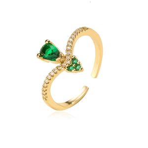Detailed close-up of gold-plated ring with a green teardrop-shaped gemstone and cubic zirconia