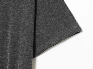Macro detail of dark grey knitted fabric showing premium soft texture and ribbed pattern