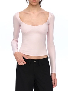 Close-up of pink long-sleeve T-shirt featuring a ribbed texture and deep U-neckline