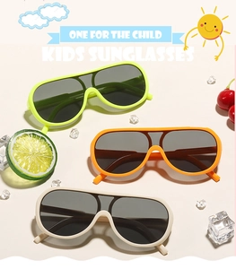 Close-up of colorful kids sunglasses in green and orange with UV protective lenses
