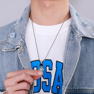 Detailed close-up of astronaut pendant on silver titanium steel snake bone chain necklace