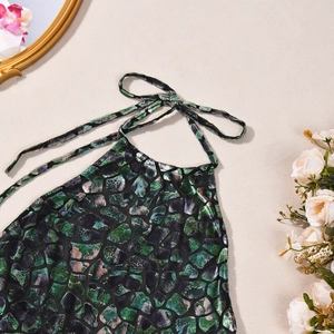 Detailed view of halter neck jumpsuit with green purple metallic shimmer and velvet texture