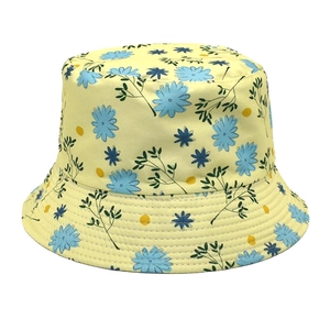 Detail of yellow bucket hat with blue floral print and reinforced stitching on the brim