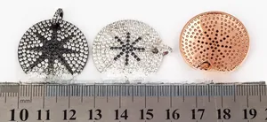 Close-up of three 2.8cm micro-pave star pendant charms in black, silver and rose gold