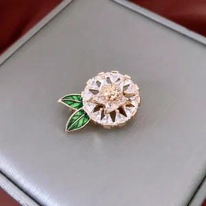 Exquisite 14K gold plated flower brooch with crystal petals and green enamel leaves