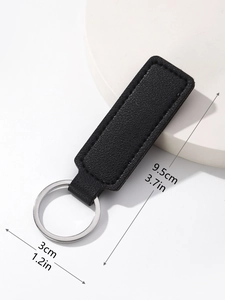 Detail view of 9.5cm black PU leather keychain with litchi texture and silver ring