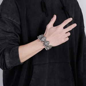Detail of silver lion head link bracelet in polished stainless steel for men