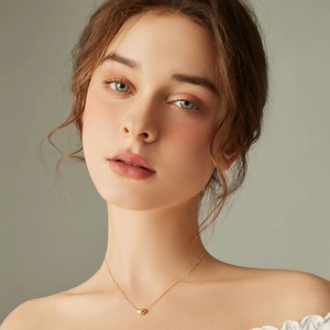 Minimalist gold stainless steel heart pendant necklace for women on a model