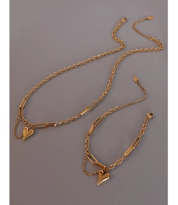 Detail of 18k gold heart necklace and bracelet set with chunky chain and polished pendants