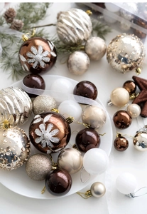Close-up of champagne and brown Christmas balls with glitter and matte finishes