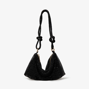 Detail of black beaded rhinestone mesh handbag with gold metal rings and zipper
