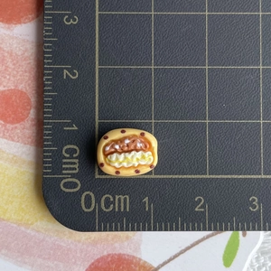 Macro view of miniature strawberry ice cream bread model on a metric cutting mat
