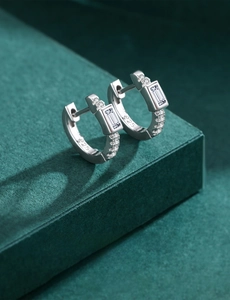 Macro shot of 925 sterling silver hoop earrings with rectangular cut zircon stones