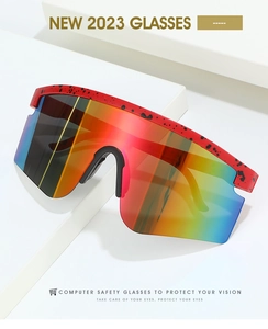 Detail of red cycling goggles with rainbow lenses and splatter texture on a white background