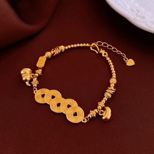 Detail of vintage gold-plated bracelet with ancient Chinese coins and gourd charms