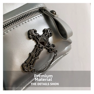 Detail of metallic silver PU backpack with gothic cross rivet and chain accents