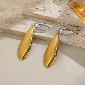 Détail de boucles d'oreilles goutte minimalistes avec pendentifs ovales dorés sur pierre