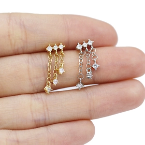 Détail macro de mini boucles d'oreilles à pampilles en forme de cœur avec zircons brillants