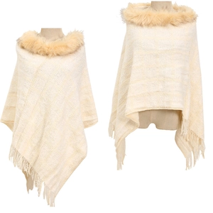 Detail showing the beige knit poncho texture, faux fur collar, and fringe tassels at the hem