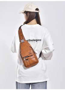 Detail view of brown vintage PU leather chest bag featuring WEIXIER logo and metal D-ring