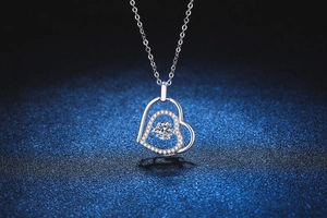 Macro shot of s925 sterling silver double heart necklace with a dancing moissanite stone