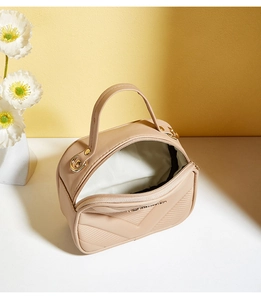 Detailed interior of a beige V-quilted small square crossbody bag with top zipper